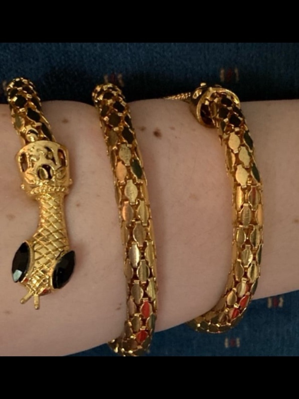 Vintage gold-tone mesh snake wrap bracelet with black eyes.